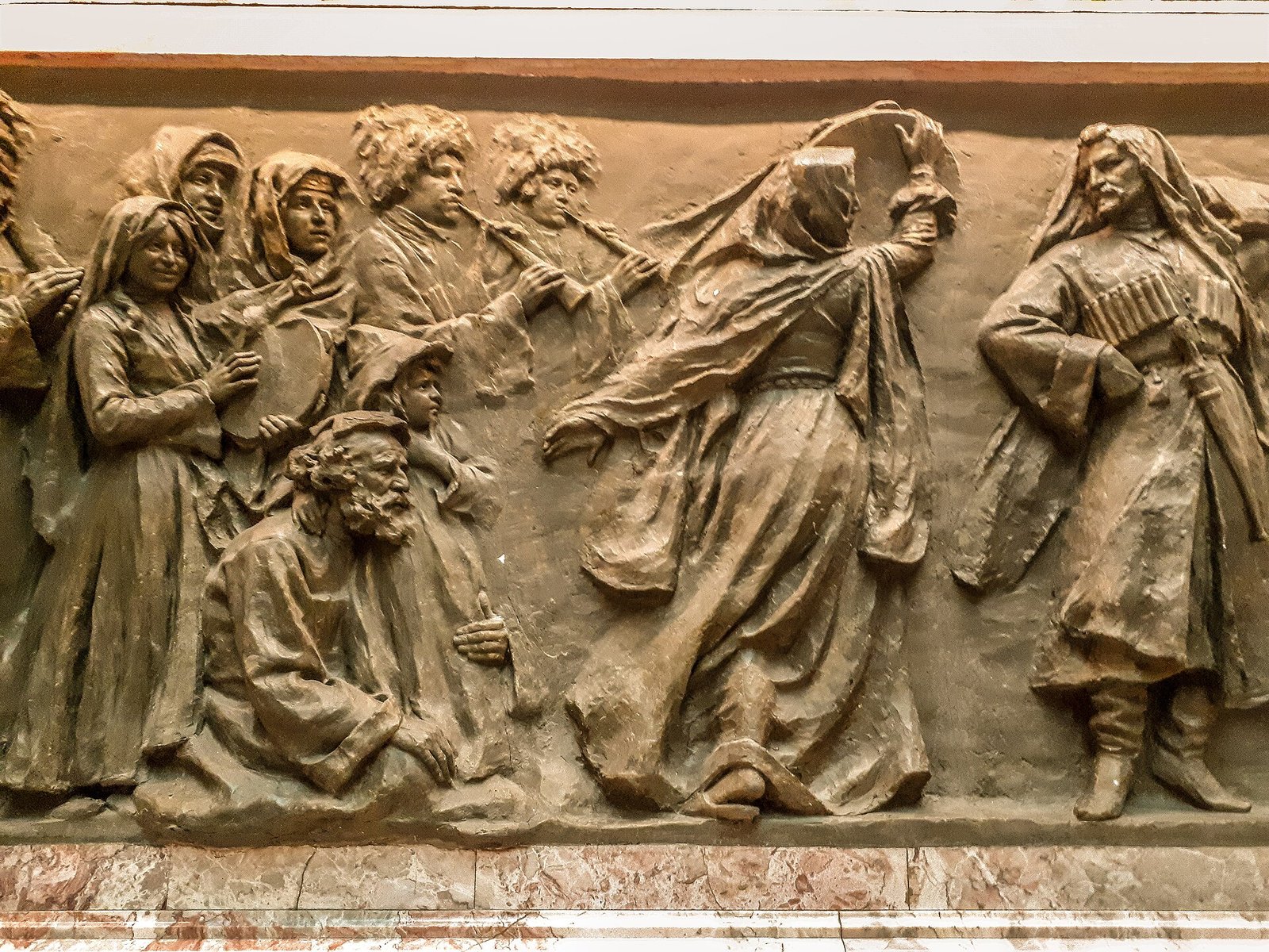 Part of the sculpted frieze in the Marble Hall: dancers in traditional costume