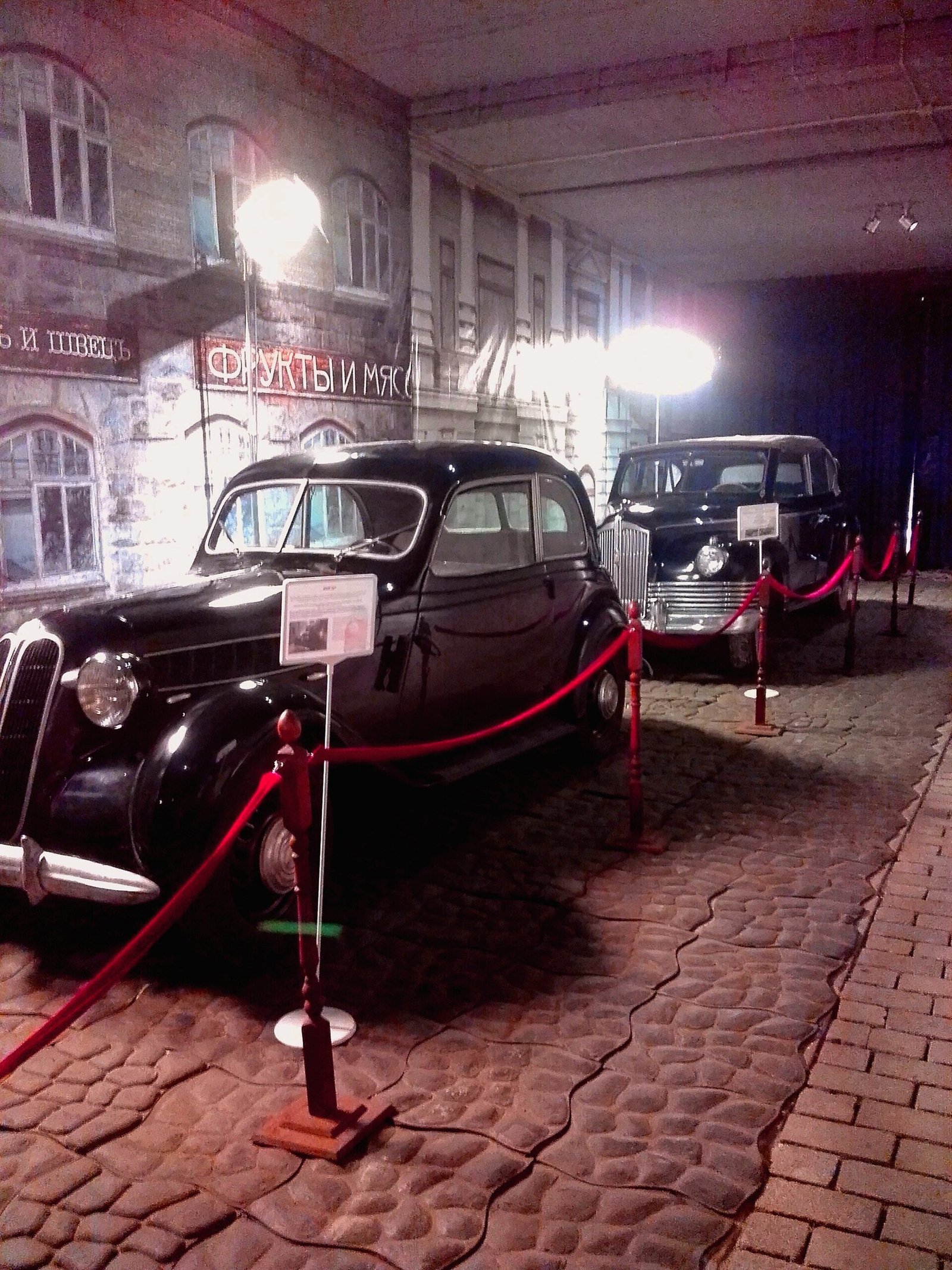 Vintage cars in front of a street set