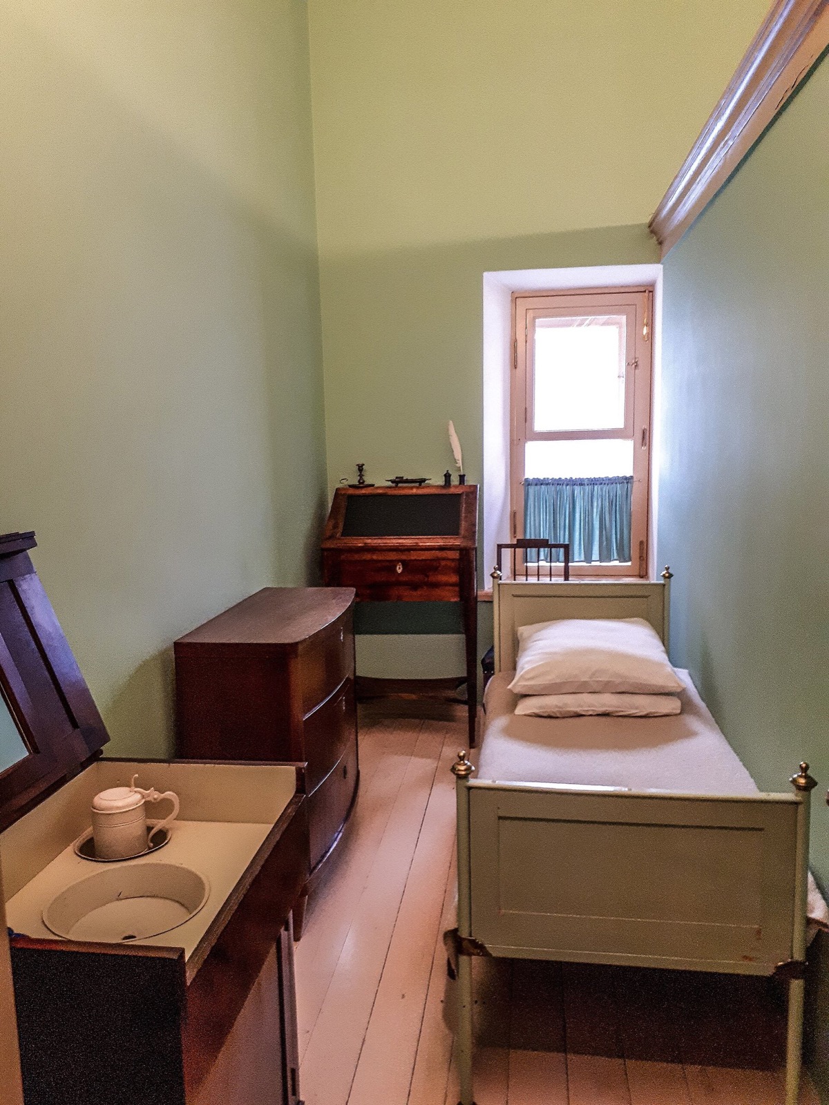 Pushkin's room: bed, writing desk and washstand by the window