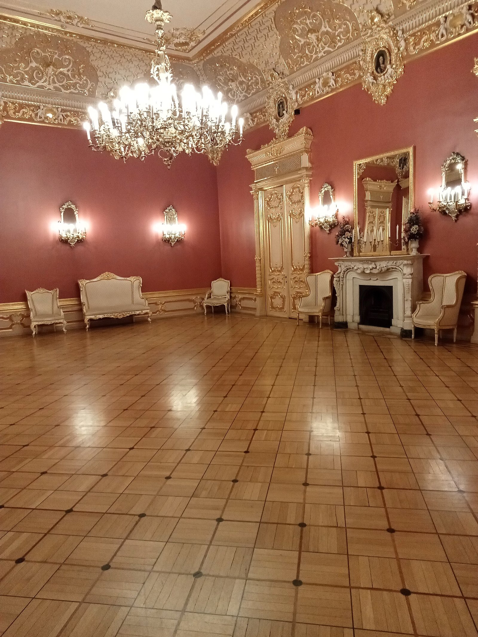 One of the theatre's grand foyers: chandelier, fireplace and gilded stucco